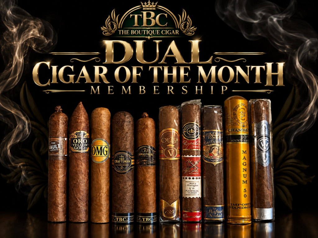 Row of assorted premium cigars lined up on a reflective surface under gold lettering that says Dual Cigar of the Month Membership, against a black background.