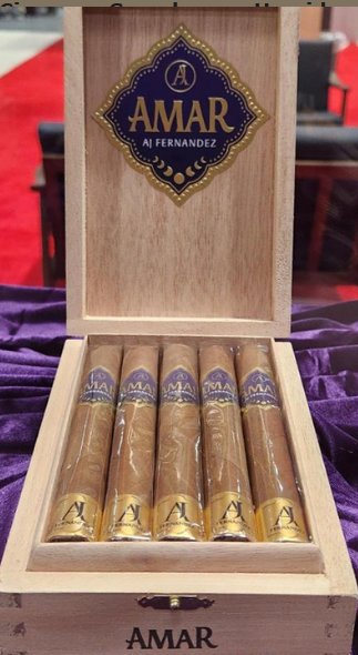 Open wooden cigar box showing six AMAR cigars with gold-purple bands, AMAR logo on the inner lid and box base.