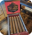 Five cigars in an open red box labeled Tailgate on a wooden surface, laid in a row.