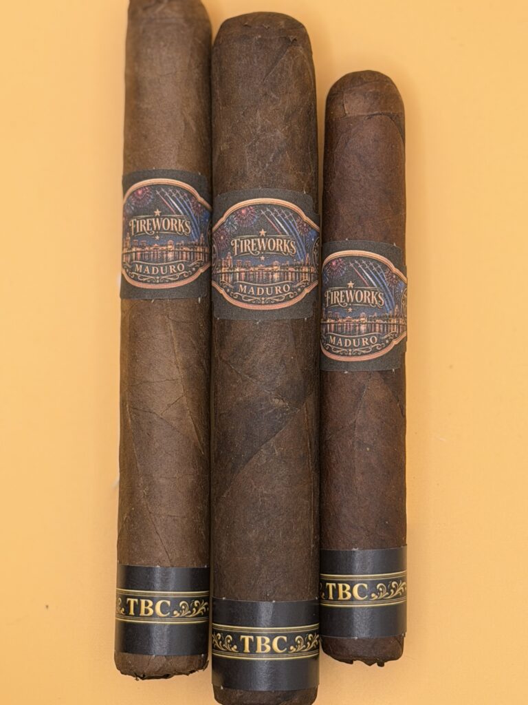 Three Maduro cigars with decorative Fireworks bands shown against an orange background.
