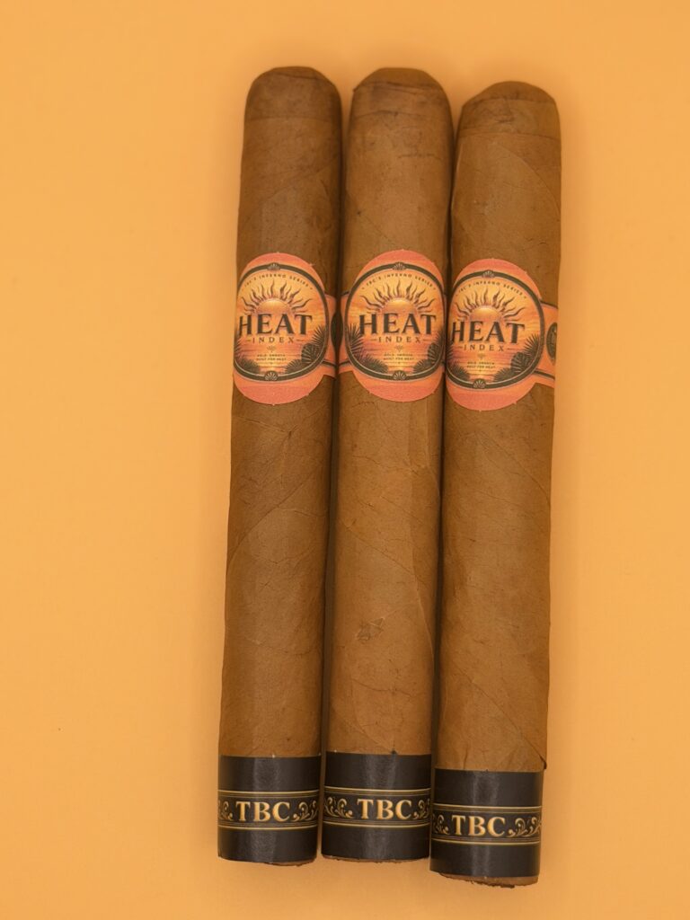 Three cigars with orange bands reading TBC, placed upright on an orange background.